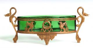 Appraisal: Elliptical-shaped green glass insert with pointed ends nestled within a