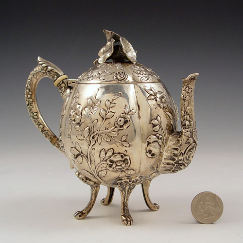 Appraisal: GERMAN SILVER REPOUSSE TEA POT Floral repousse design with applied