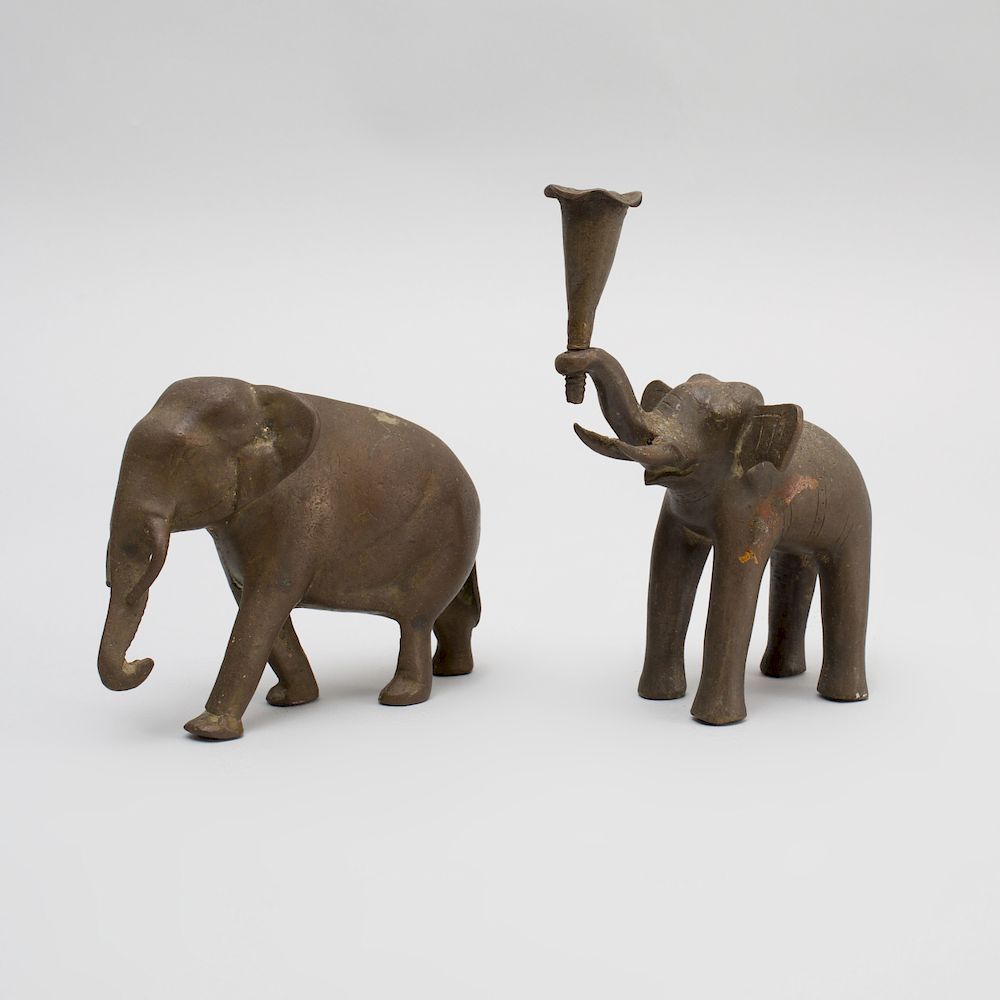 Appraisal: Two Indian Bronze Models of Elephants The baby elephant holding