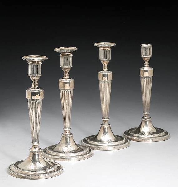 Appraisal: A George III silver set of four candlesticks with three