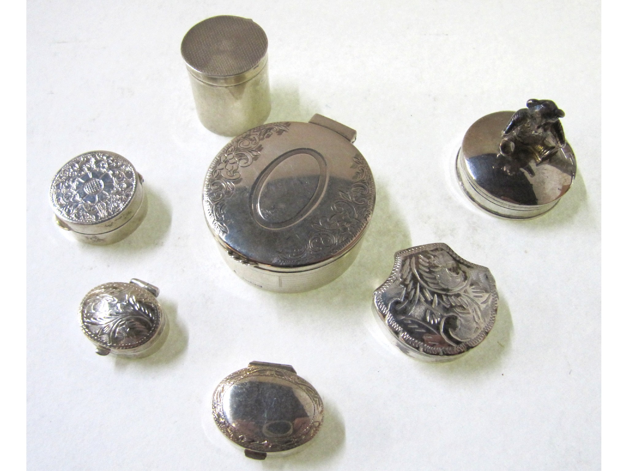 Appraisal: A lot comprising seven assorted silver pill boxes