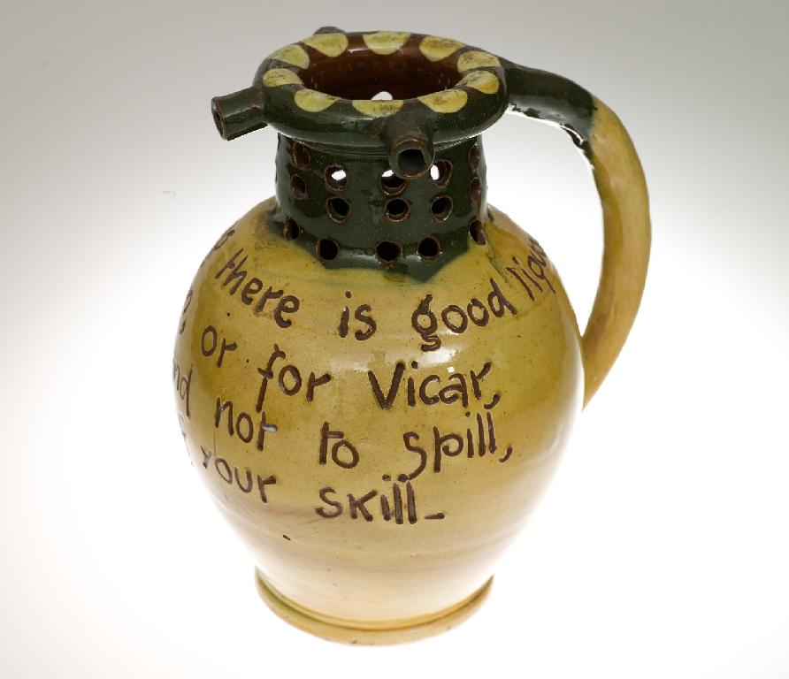 Appraisal: BARON OF BARNSTAPLE POTTERY PUZZLE JUG of characteristic form inscribed