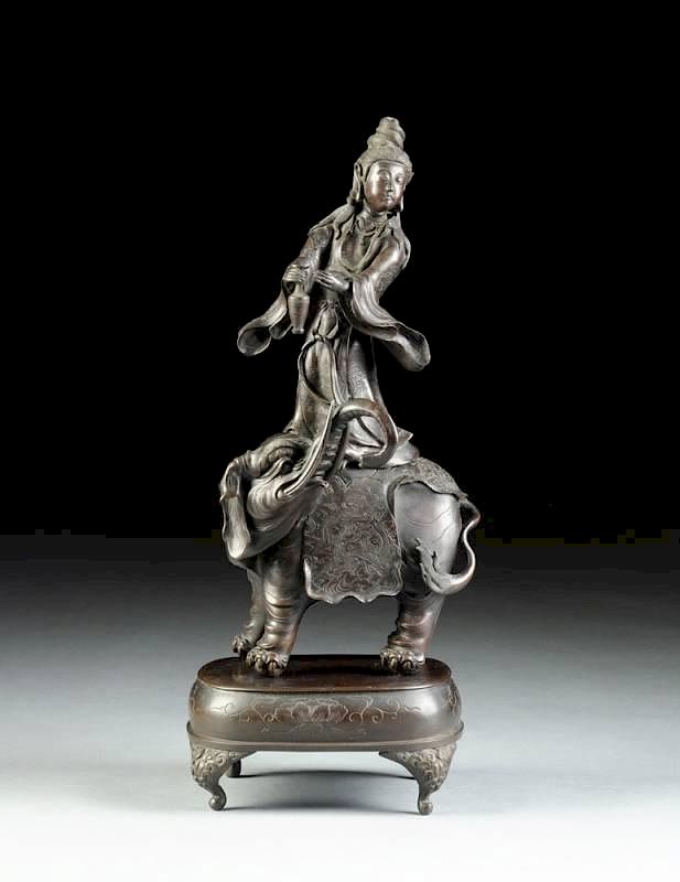 Appraisal: A CHINESE PATINATED BRONZE FIGURAL GROUP OF GUANYIN AND ELEPHANT