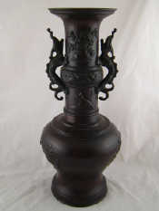 Appraisal: An Oriental bronze sectional vase with dragon handles Ht cm