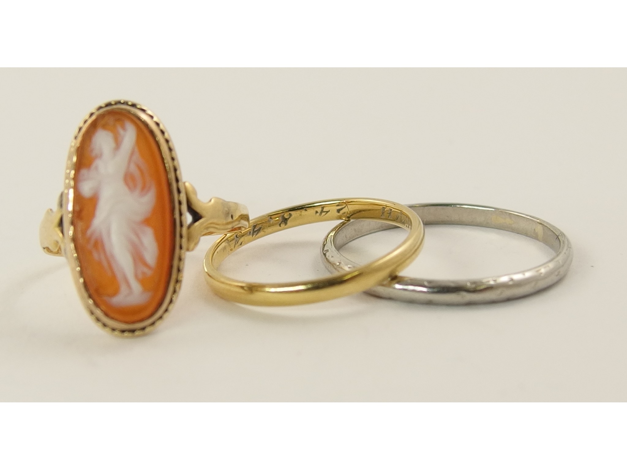 Appraisal: A yellow metal glass cameo ring a platinum wedding ring