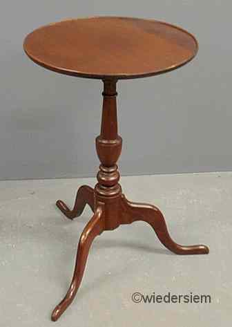 Appraisal: Mahogany candlestand with a circular dish top and snake feet