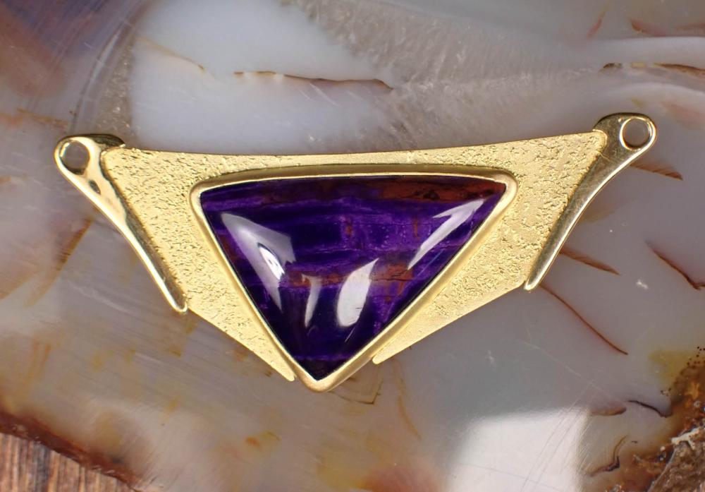 Appraisal: SUGILITE AND EIGHTEEN KARAT YELLOW GOLD PENDANT bezel set with