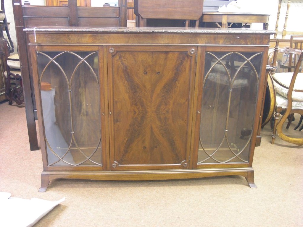 Appraisal: A George V mahogany display cabinet central quarter-veneered cupboard enclosing