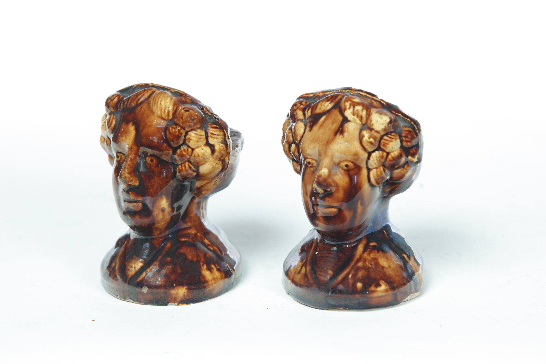 Appraisal: PAIR OF ROCKINGHAM FIGURAL WINDOW STOPS American mid th century