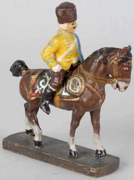 Appraisal: Composition cm Mounted Hussar Hussar mounted on composition horse on