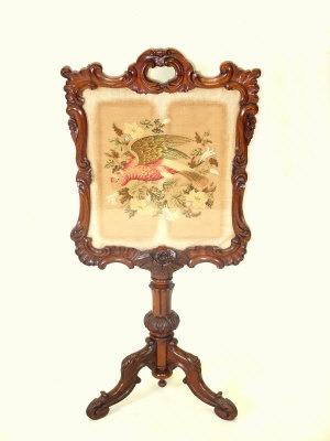 Appraisal: A rosewood fire screen th century the scrolled and pierced