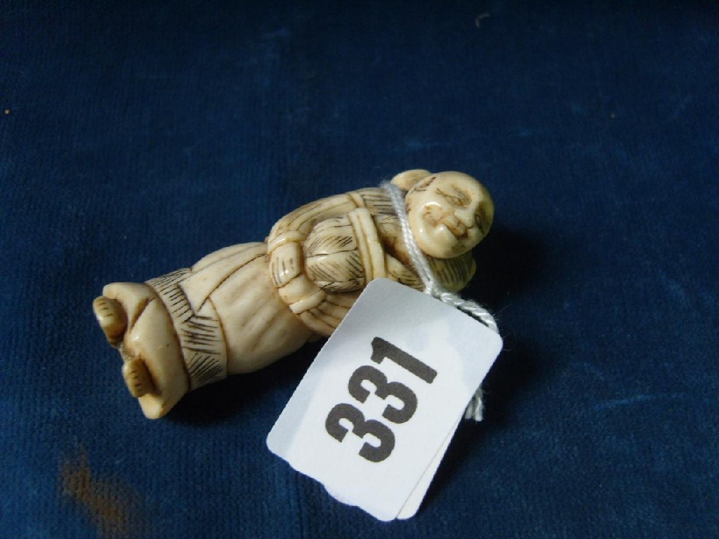 Appraisal: A Japanese carved ivory figure of a heavily robed man