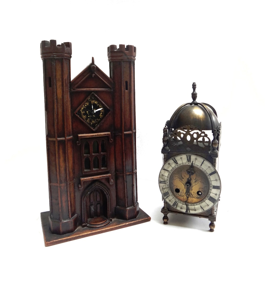 Appraisal: A stained pine cased mantel clock early th century modelled