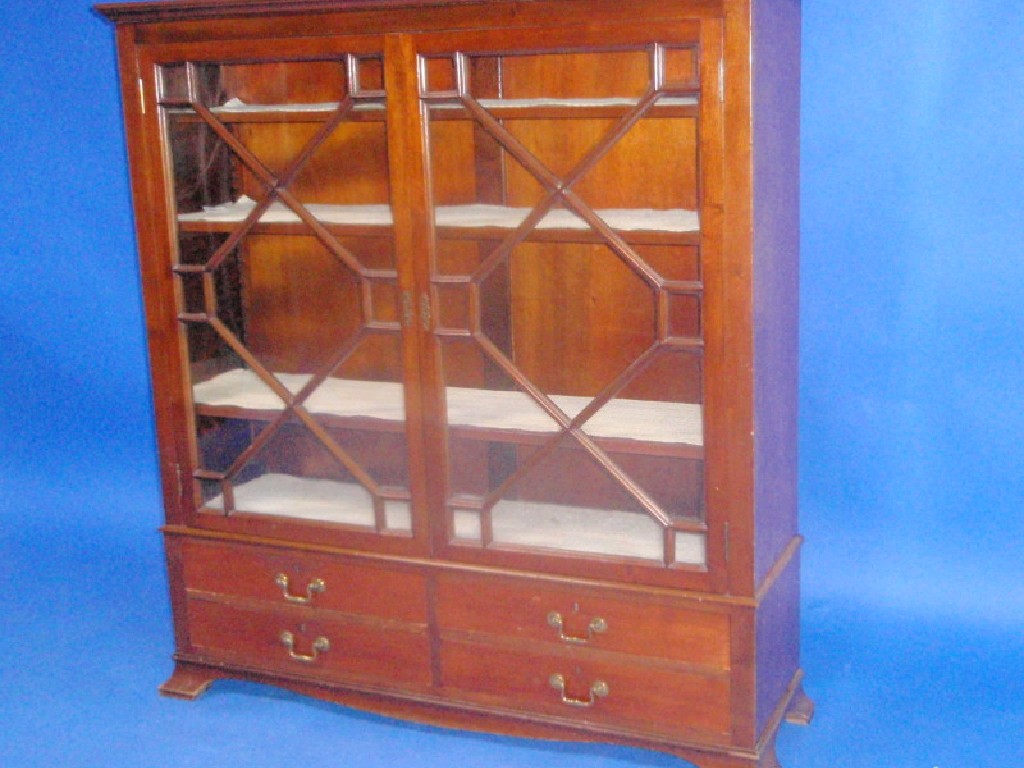 Appraisal: A mahogany display cabinet with two astragal doors over four