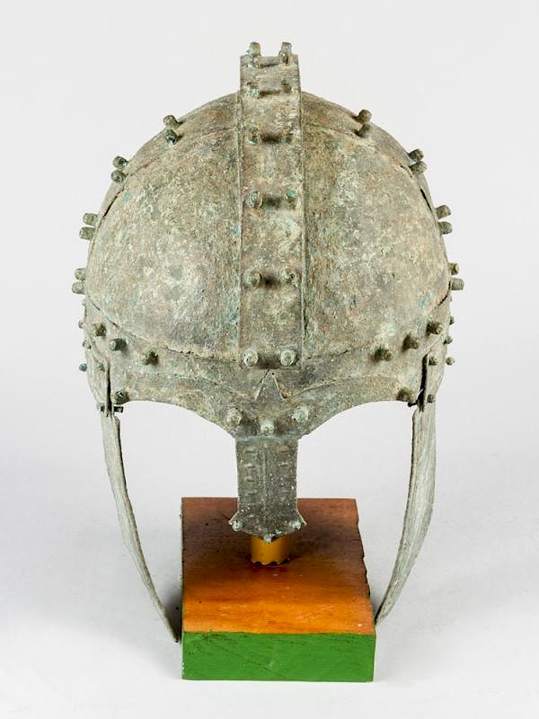 Appraisal: A bronze warrior helmet A bronze or copper warrior helmet