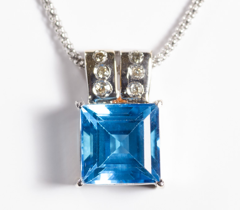 Appraisal: BLUE TOPAZ AND DIAMOND PENDANT NECKLACE The k white gold