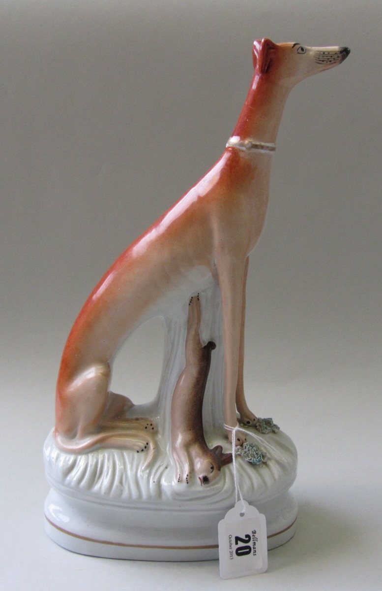 Appraisal: A Staffordshire pottery figure of a greyhound standing above a