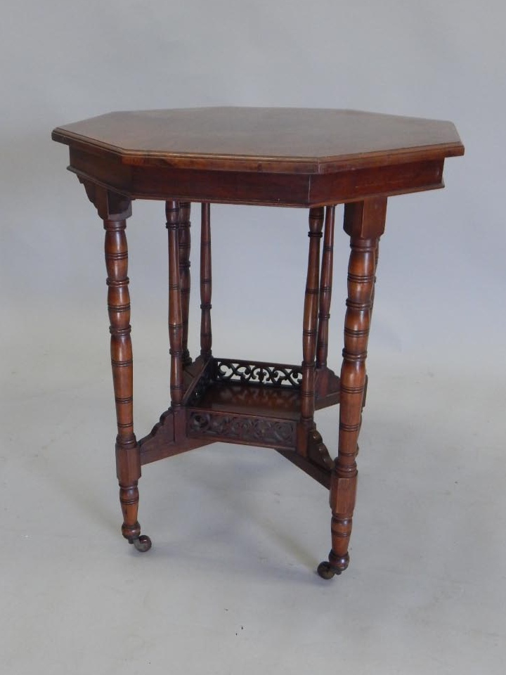 Appraisal: An Edwardian walnut occasional table the octagonal top on a