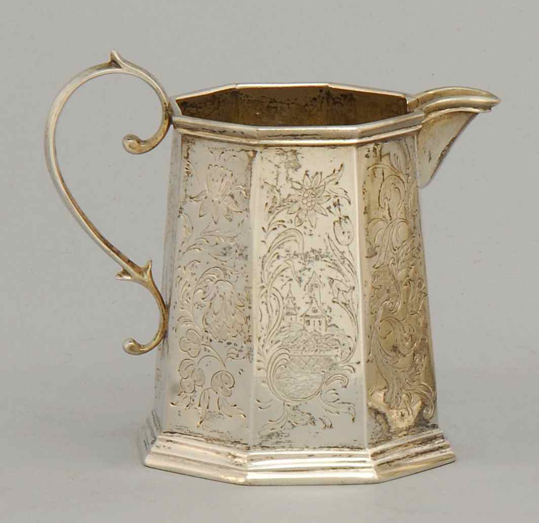 Appraisal: AMERICAN SILVER CREAMERCirca - Engraved with floral and village scenes