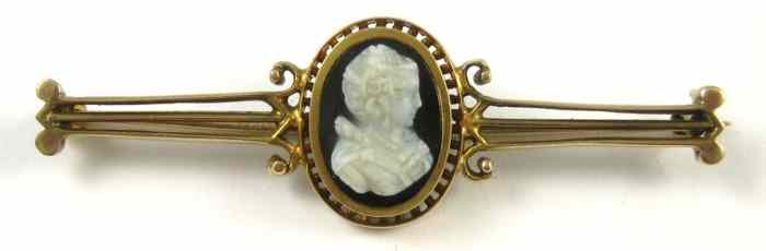 Appraisal: CAMEO AND TEN KARAT GOLD BROOCH featuring the black and