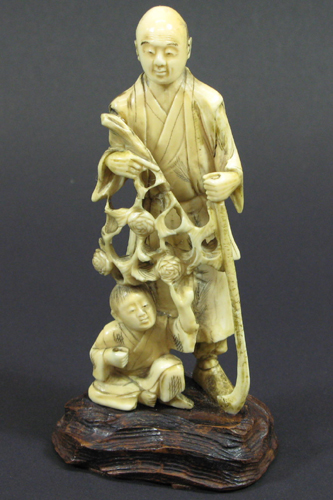 Appraisal: A JAPANESE IVORY CARVED FIGURE OF FATHER AND SON The