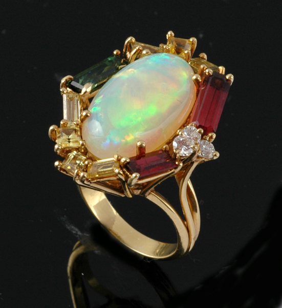 Appraisal: AN OPAL AND DIAMOND CLUSTER RING The oval solid crystal