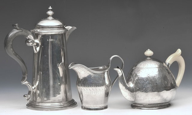 Appraisal: A SILVER ENGRAVED TEAPOT with ivory handle and finial a