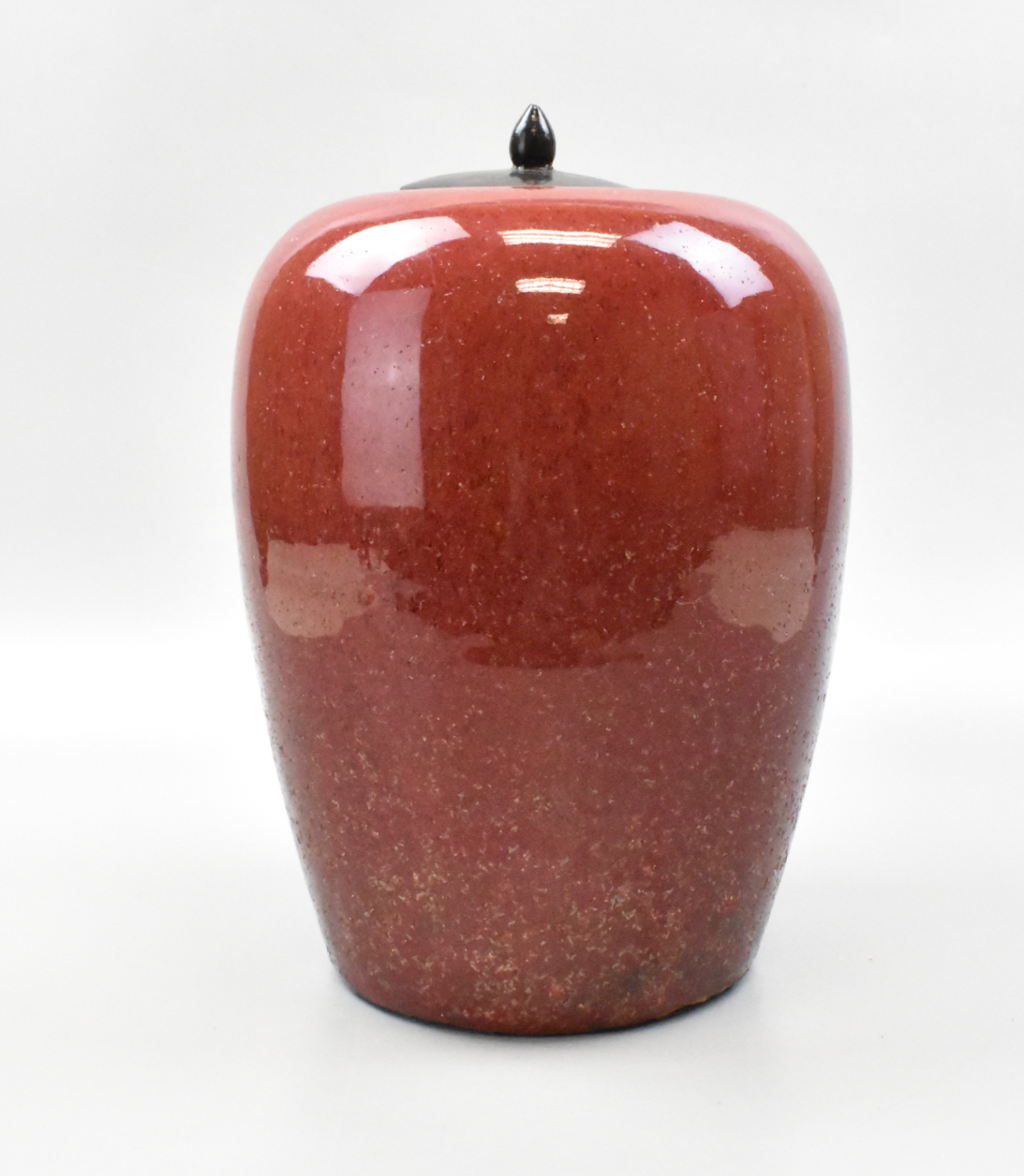 Appraisal: A Chinese red flambe glazed covered jar dating from the