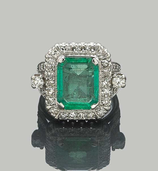 Appraisal: An emerald and diamond ring centering a rectangular-cut emerald weighing