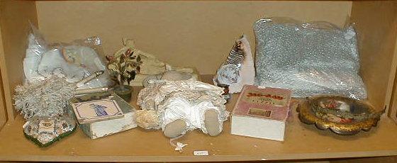 Appraisal: Two jigsaw puzzles linens doll and sundries all on shelf