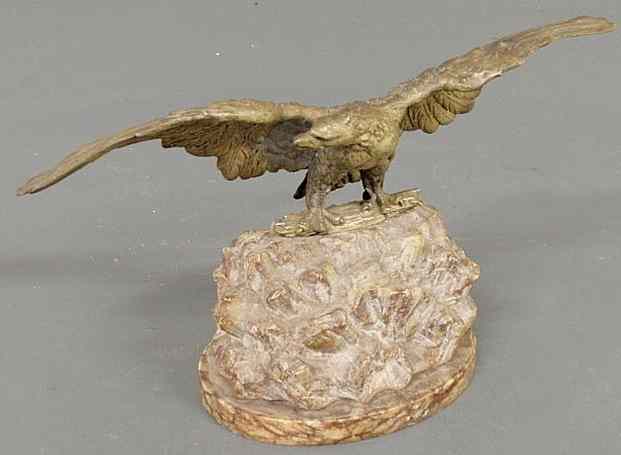 Appraisal: Silvered cast metal spread winged eagle mounted on a carved