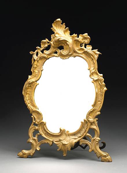 Appraisal: The shaped beveled mirror plate within flowering rocaille scrolls raised