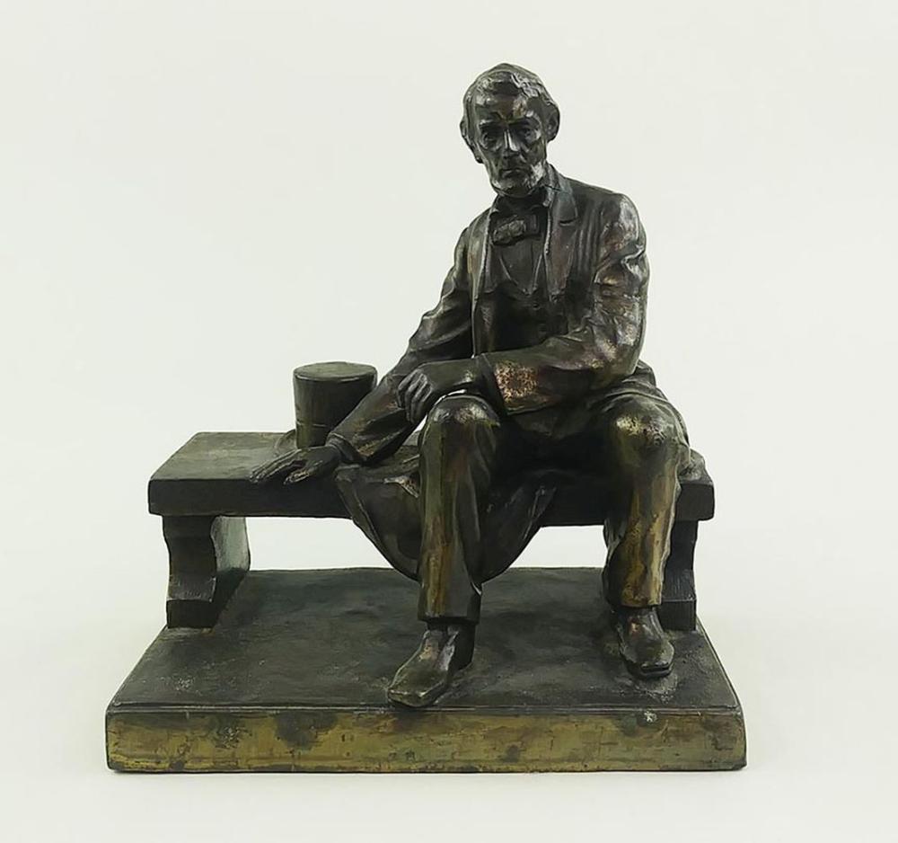 Appraisal: BRONZE CLAD METAL FIG OF LINCOLN SEATED ON A BENCHEarly