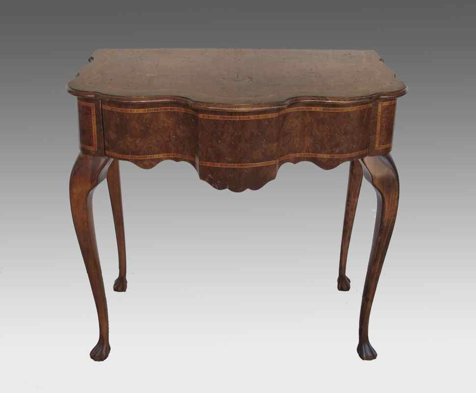 Appraisal: RICHLY BURLED WRITING TABLE Exaggerated serpentine sides and front single