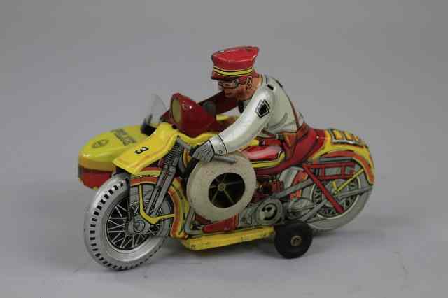 Appraisal: POLICE SQUAD MOTORCYCLE Marx lithographed tin yellow cycle with police