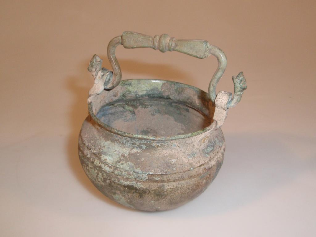 Appraisal: A repaired Greek bronze bucket or stitula with a swinging