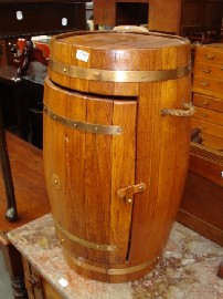 Appraisal: Teak and copper banded wire barrell converted into a drinks