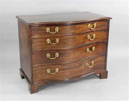 Appraisal: A George III mahogany serpentine chest of four graduated long