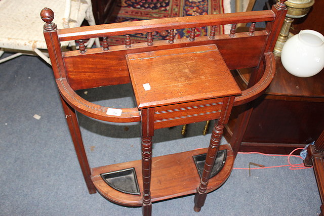 Appraisal: A VICTORIAN WALNUT STICK STAND with turned finials a central