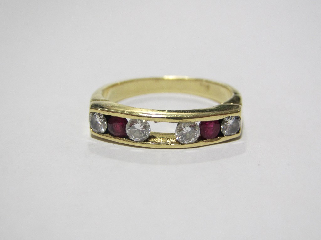 Appraisal: Eighteen carat gold channel set ruby and diamond half hoop