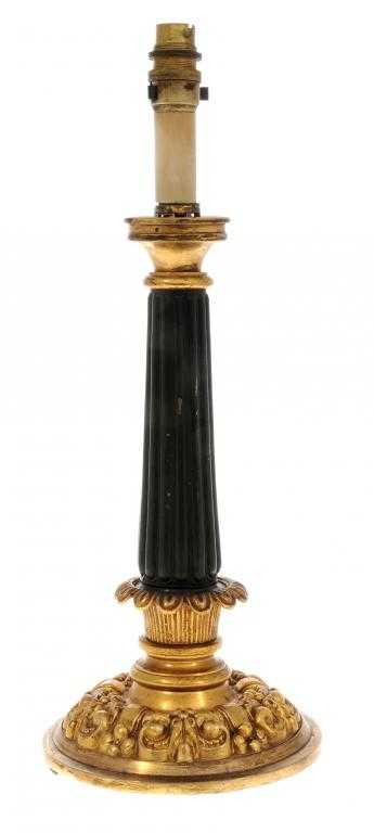 Appraisal: A GILT AND PATINATED BRASS LAMP the reeded shaft on