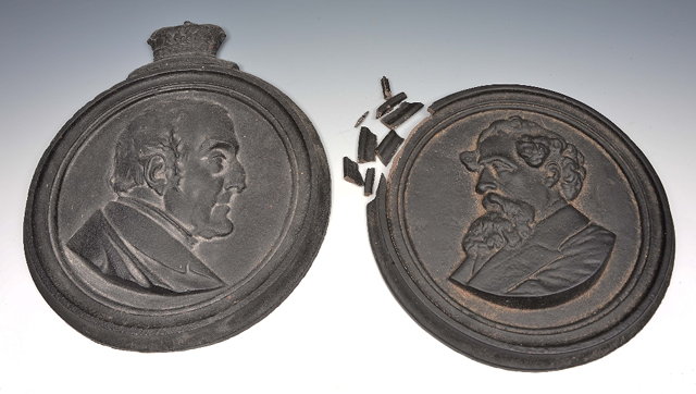 Appraisal: Pair of cast iron roundelswith profile busts to include Dickens