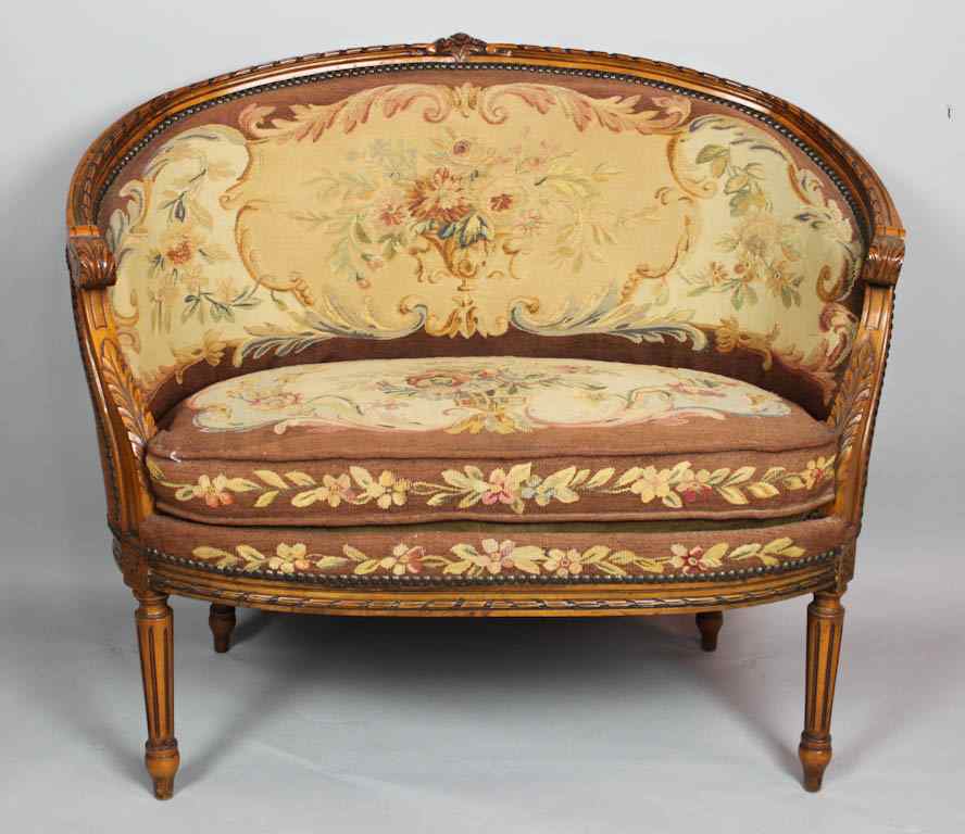 Appraisal: LOUIS XVI STYLE FRUITWOOD SMALL TAPESTRY COVERED SETTEE the arched