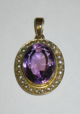 Appraisal: AN EDWARDIAN AMETHYST AND SEED PEARL PENDANT the oval cut