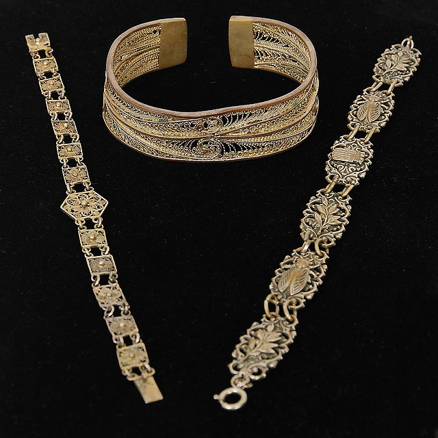 Appraisal: Two filigree patterned silver gilt metal bracelets and one bangle