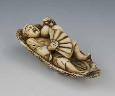 Appraisal: A Carved Ivory Netsuke of a Sleeping Man in a