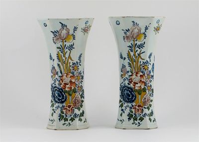 Appraisal: A pair of Delft octagonal section flared vases painted with