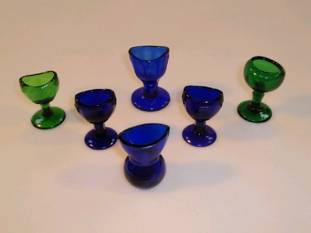 Appraisal: Four Victorian Bristol blue glass eye baths together with two