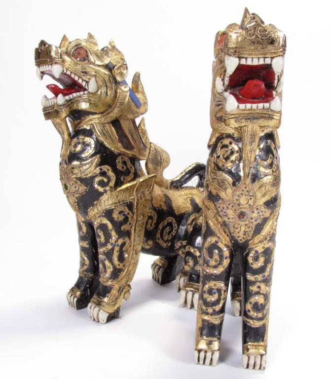 Appraisal: A pair of carved wood Balinese temple lions with painted