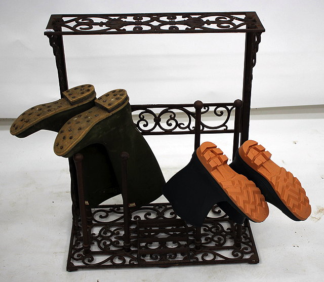 Appraisal: A VICTORIAN STYLE CAST IRON BOOT RACK with pierced scrolling